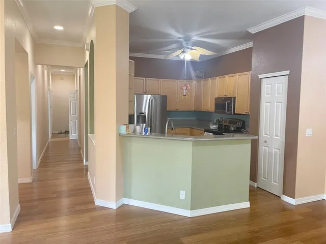 a view of a kitchen cabinets and wooden floor