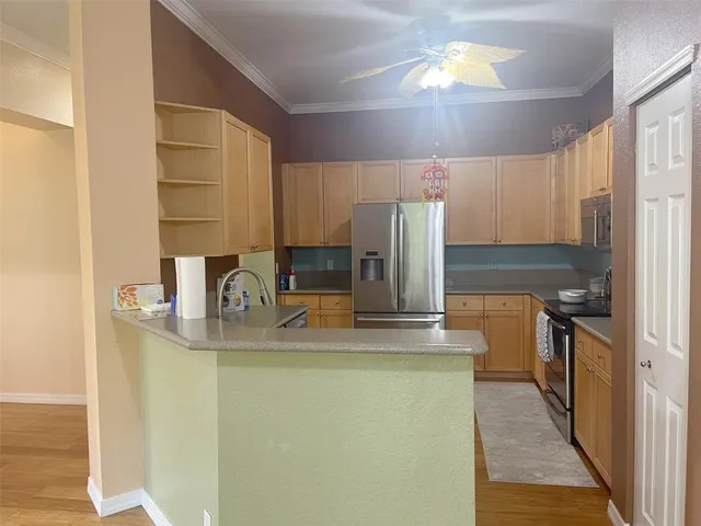 a kitchen with kitchen island a counter top space a stove and refrigerator