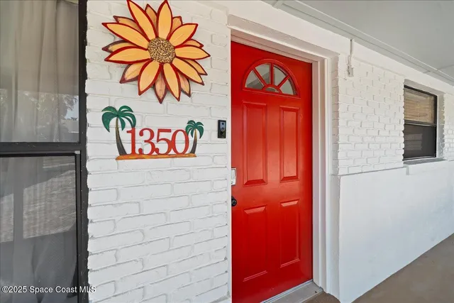 a street sign on a wall next to a blue building