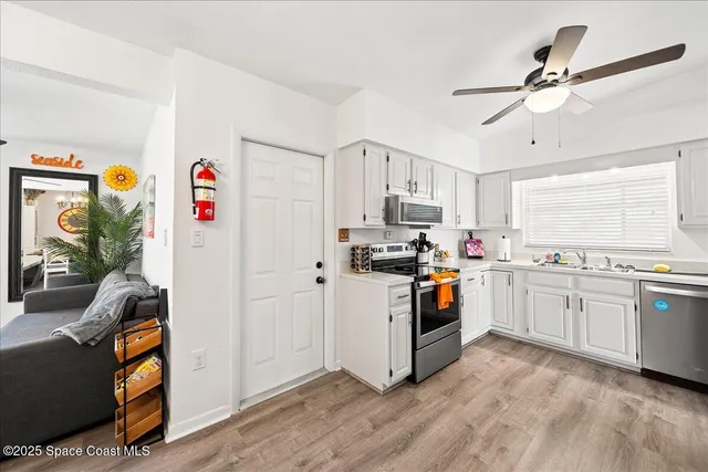 a kitchen with stainless steel appliances granite countertop a refrigerator a stove a sink and a stove