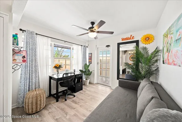 a view of a livingroom with workspace and a couch