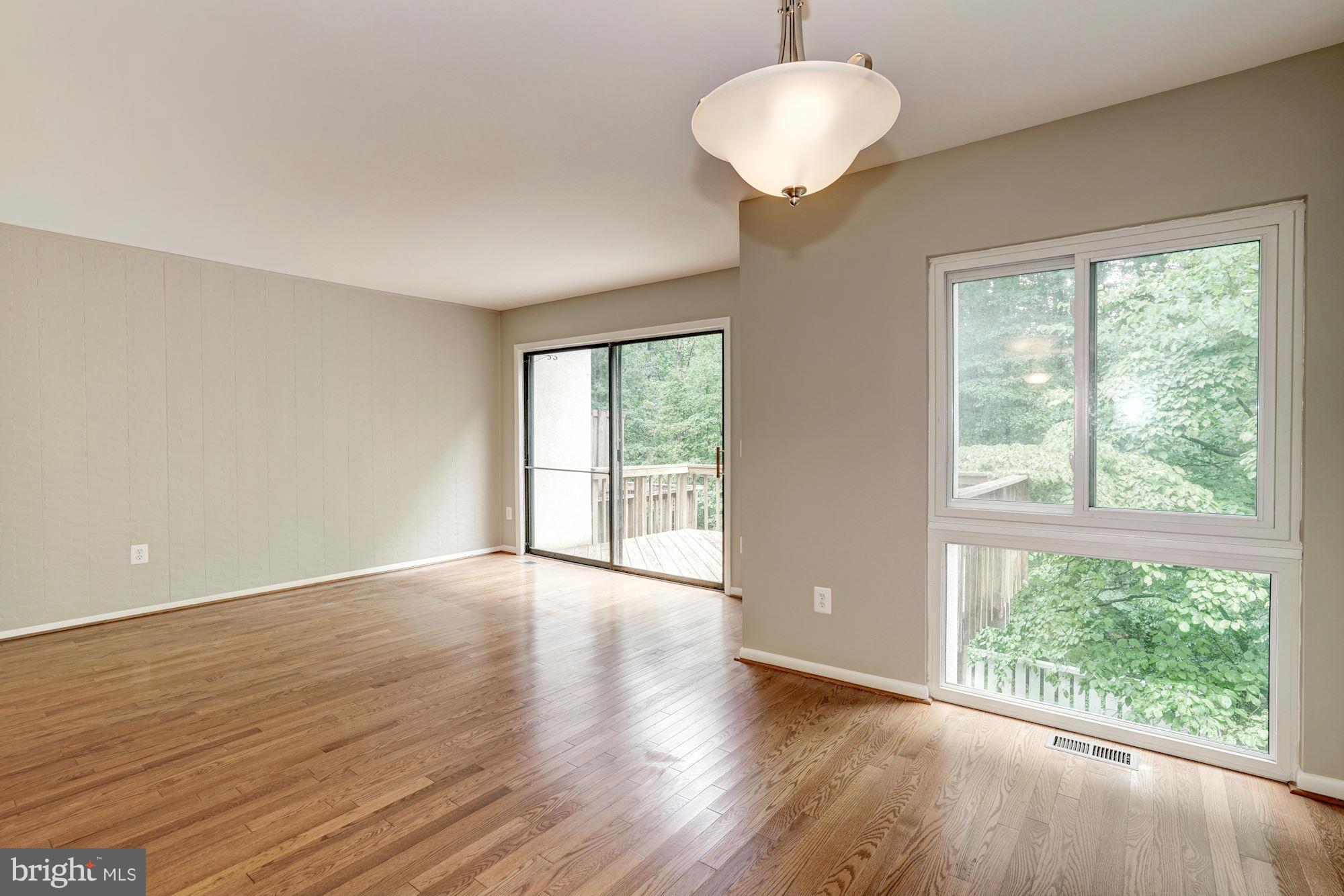 11704 Decade Court Reston, VA 20191 - Photo 11 of 30 a view of an empty room with wooden floor and a window