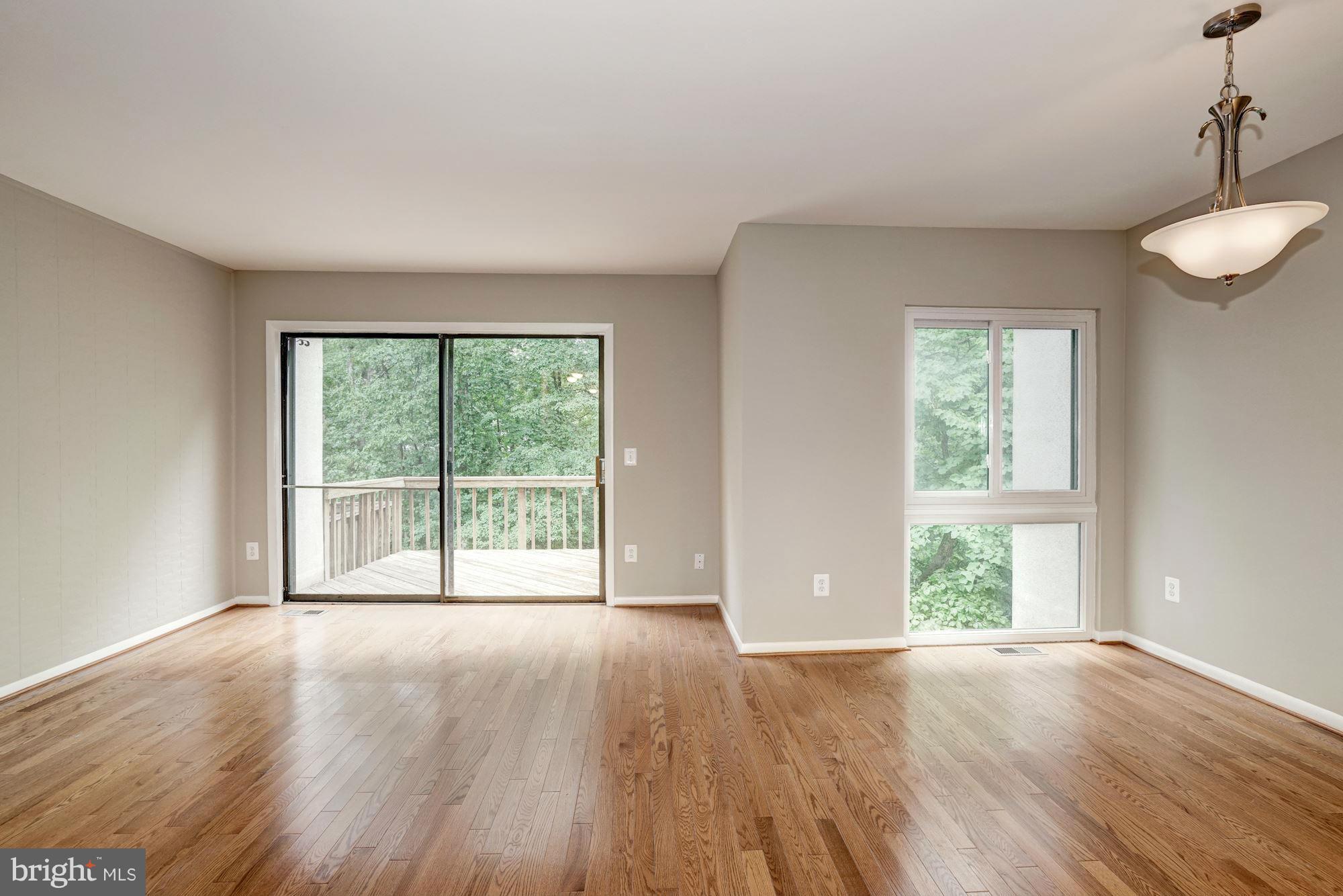 11704 Decade Court Reston, VA 20191 - Photo 13 of 30 a view of an empty room with wooden floor and a window