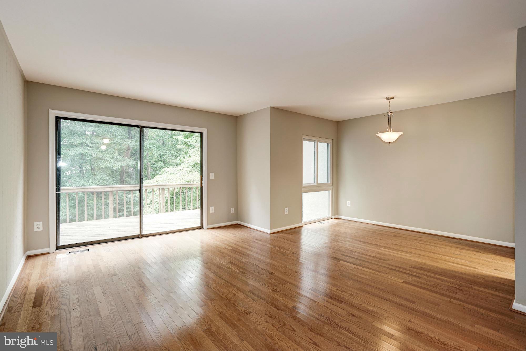 11704 Decade Court Reston, VA 20191 - Photo 14 of 30 a view of an empty room with wooden floor and a window