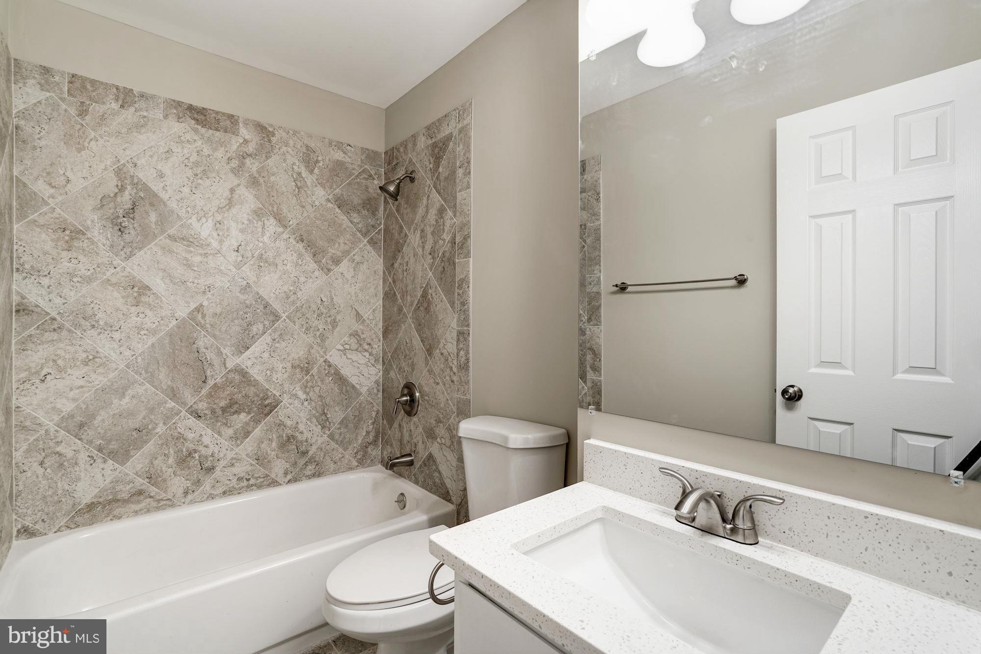 11704 Decade Court Reston, VA 20191 - Photo 23 of 30 a bathroom with a toilet a sink and a bathtub
