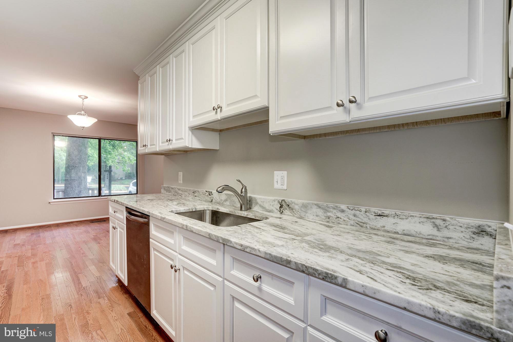 11704 Decade Court Reston, VA 20191 - Photo 9 of 30 a kitchen with granite countertop white cabinets and sink