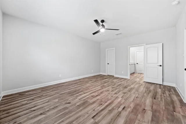 a large kitchen with a lot of counter space and stainless steel appliances