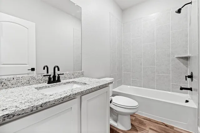 a bathroom with a sink double vanity granite and a large mirror