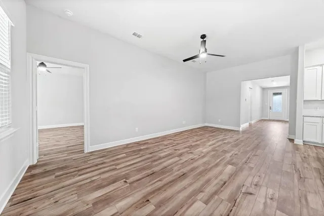 a view of a room with wooden floor