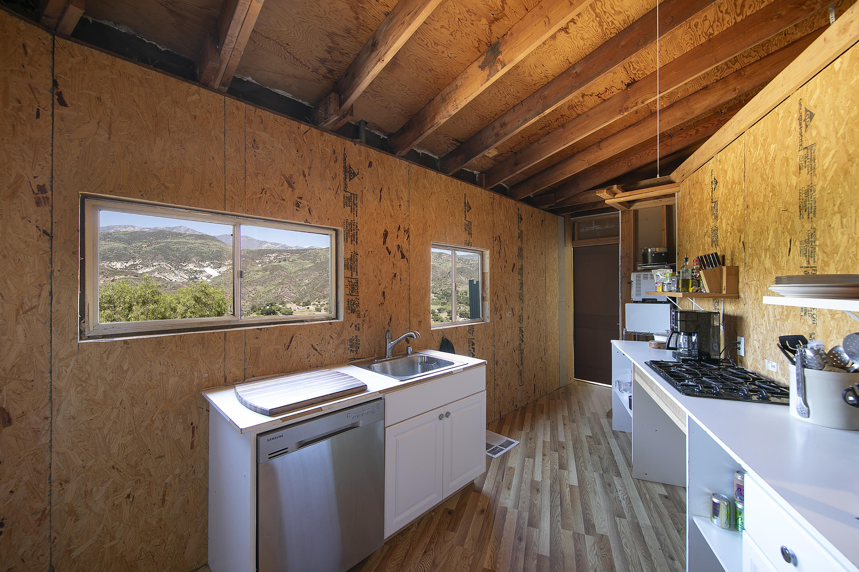 7305 Shepard Mesa Drive Carpinteria, CA 93013 - Photo 18 of 26 a kitchen with a sink appliances cabinets and a large window