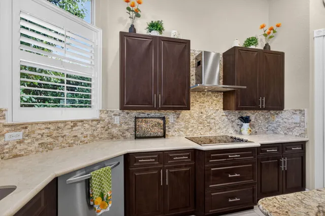 a bathroom with a granite countertop sink a toilet a mirror and shower