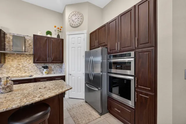 a spacious bedroom with a bed a couch and a flat screen tv