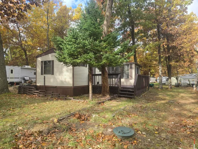 a house that has a tree in front of it