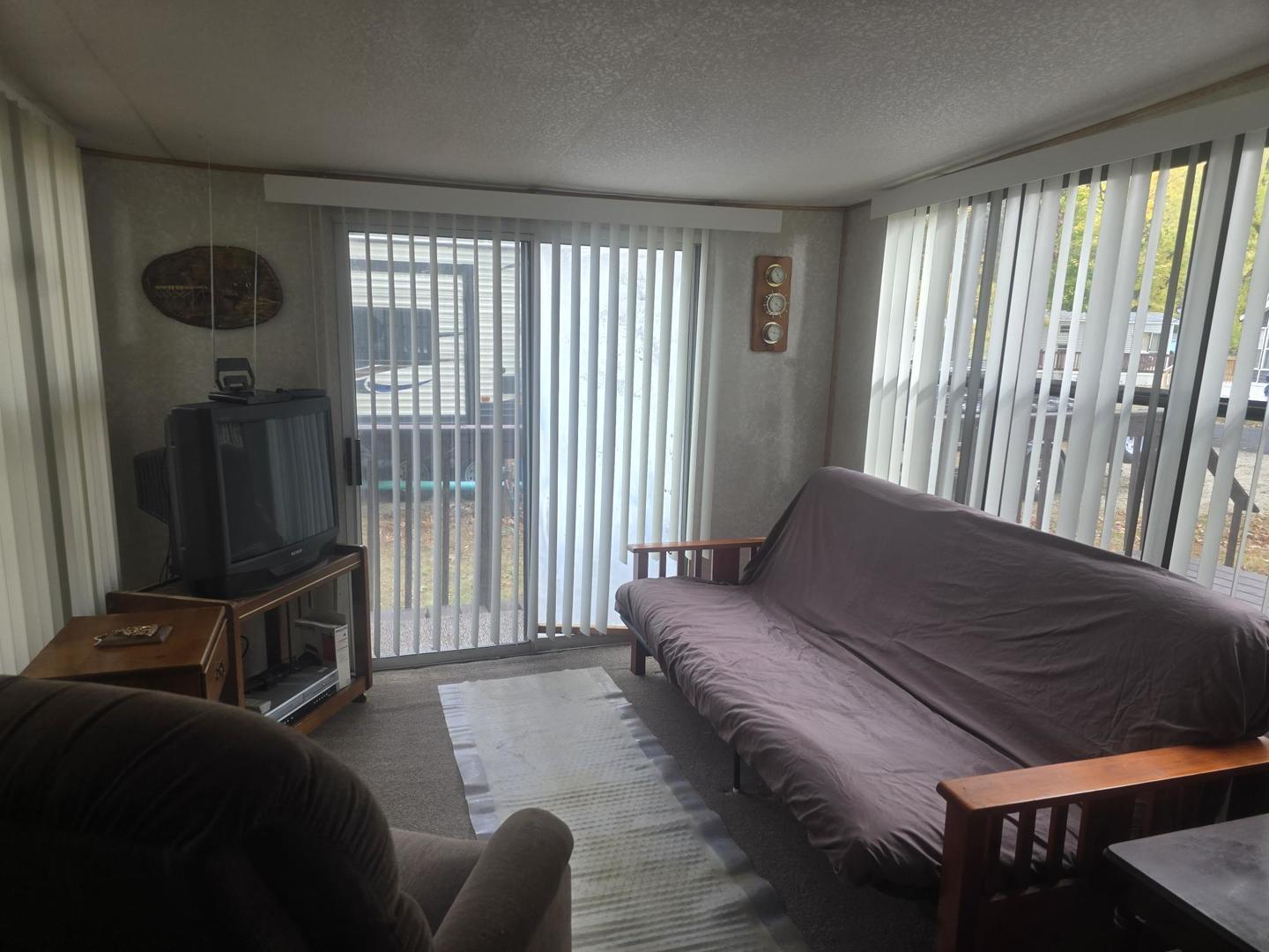 4-135 Woodhaven Sublette, IL 61367 - Photo 12 of 15 a living room with furniture and a flat screen tv