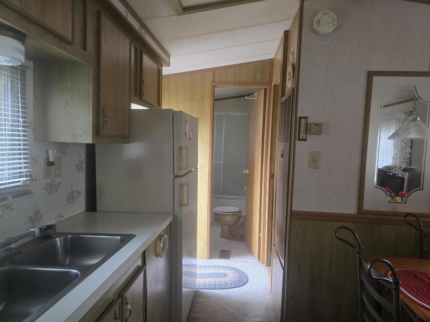 4-135 Woodhaven Sublette, IL 61367 - Photo 15 of 15 a kitchen with a sink and a refrigerator