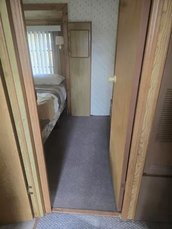 a view of bedroom with wooden floor and window