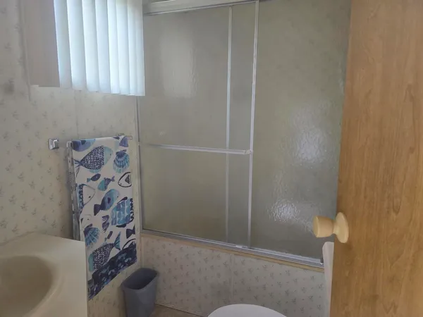 a bathroom with a bathtub and shower