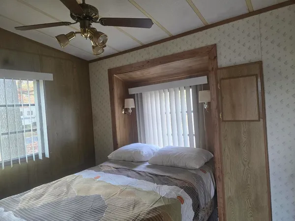 a bedroom with a bed and a window