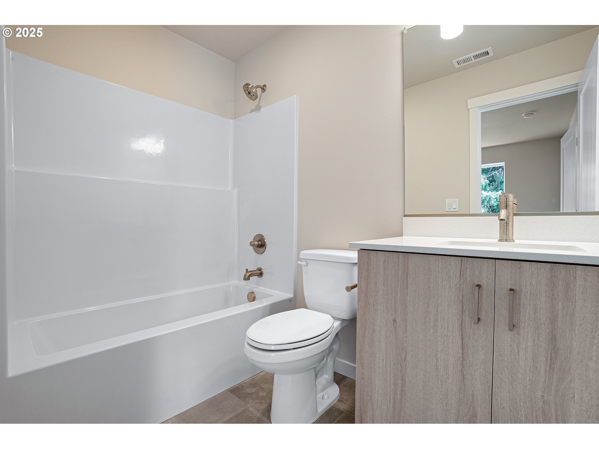 15133 East Burnside Street Portland, OR 97233 - Photo 14 of 21 a bathroom with a granite countertop sink a toilet a mirror and bathtub