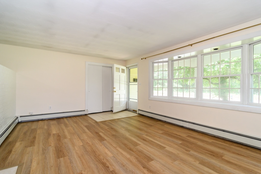 33 Eisenhower Road Framingham, MA 01701 - Photo 6 of 20 a view of an empty room with a window and wooden floor