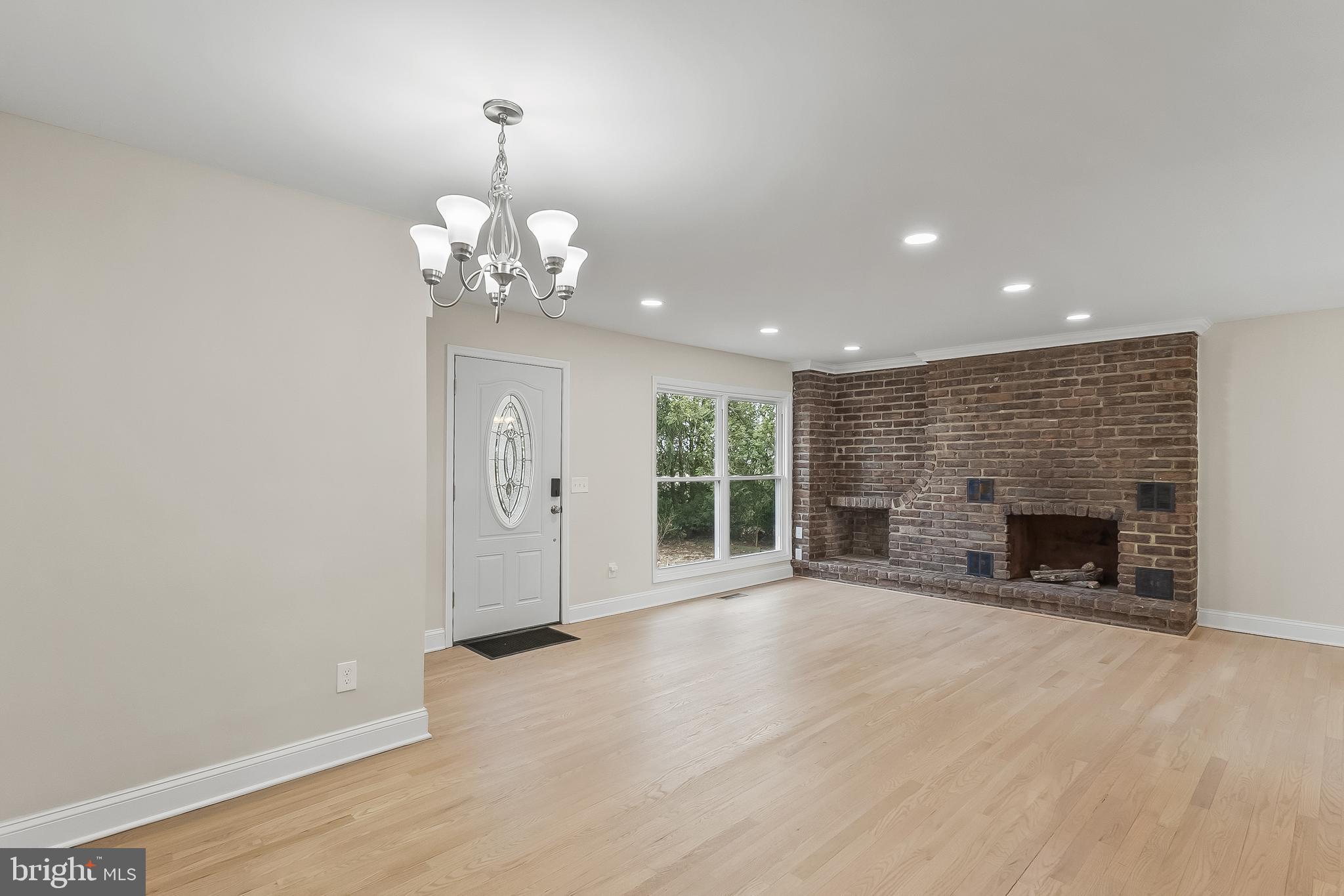 10546 Worton Road Worton, MD 21678 - Photo 11 of 33 an empty room with fireplace and windows