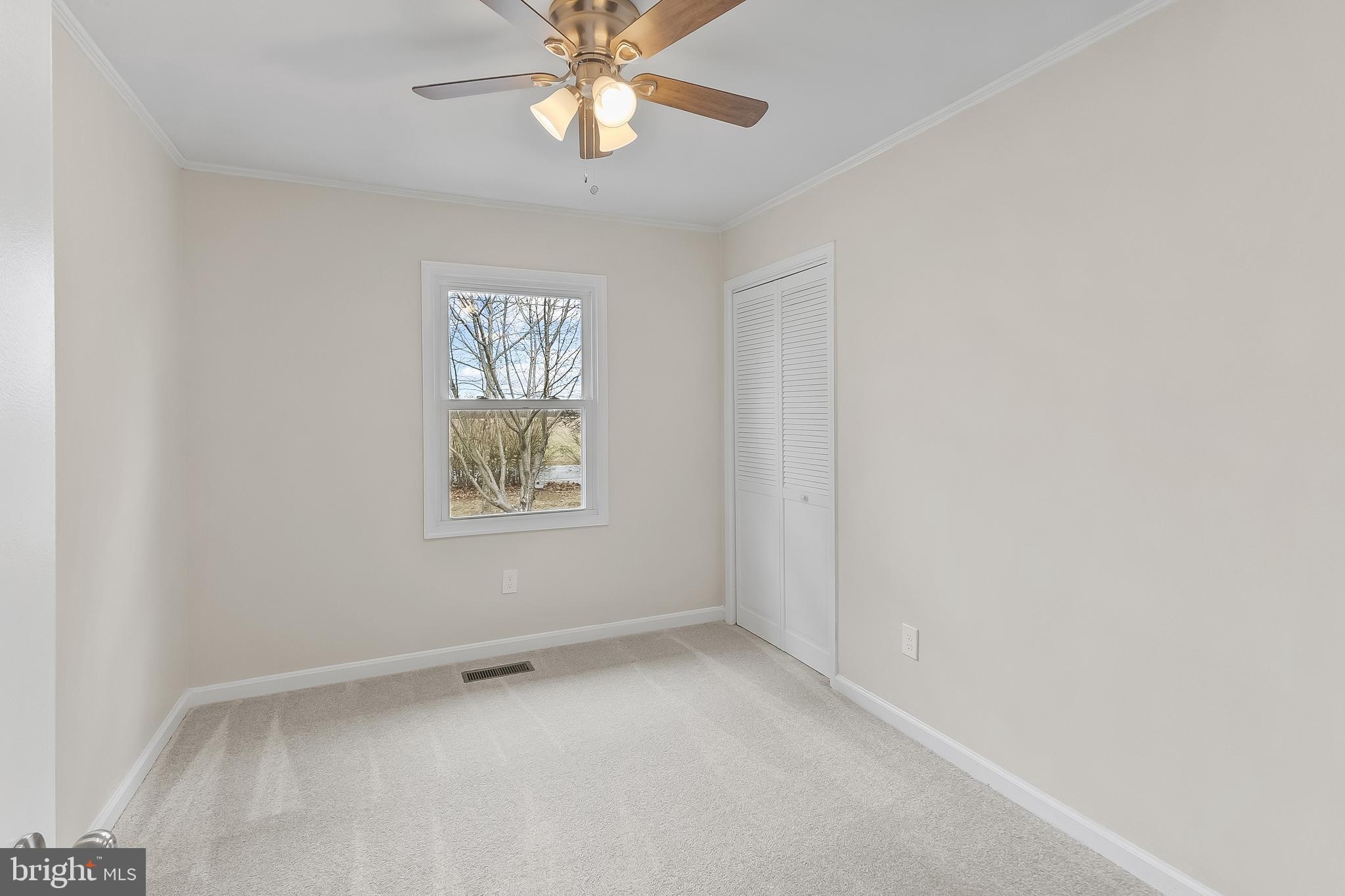 10546 Worton Road Worton, MD 21678 - Photo 13 of 33 an empty room with a window and a fan