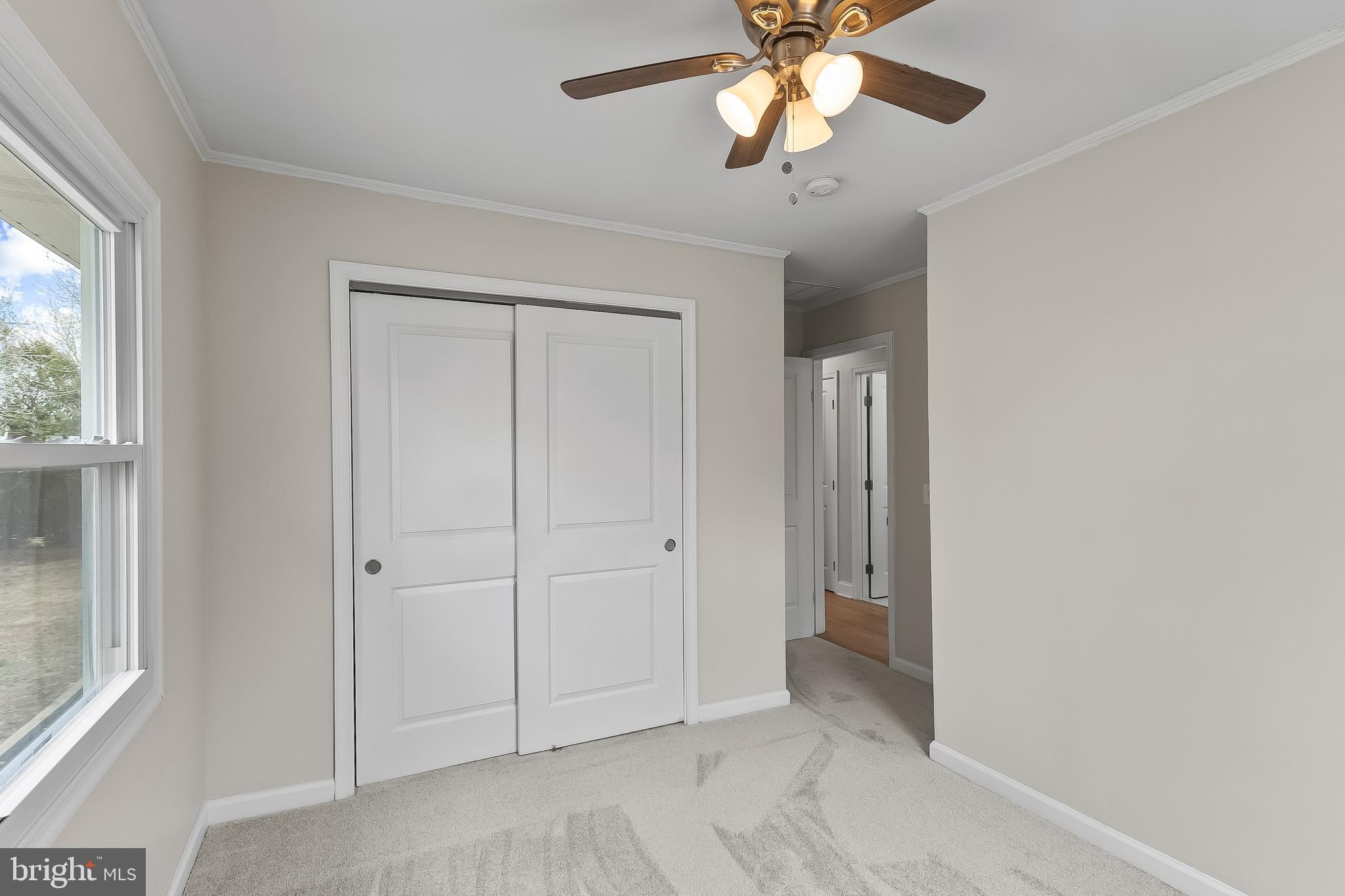 10546 Worton Road Worton, MD 21678 - Photo 18 of 33 an empty room with closet and a chandelier fan