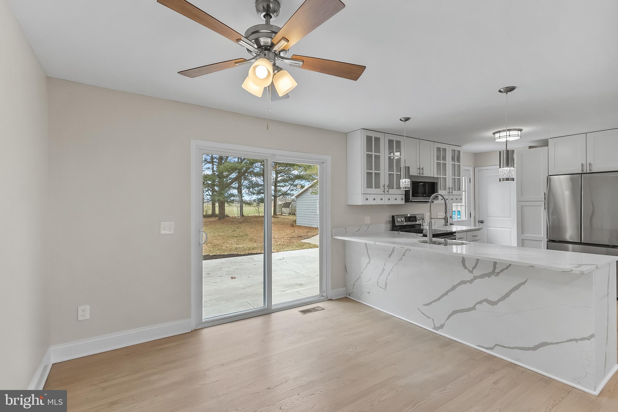 10546 Worton Road Worton, MD 21678 - Photo 4 of 33 a kitchen with stainless steel appliances a refrigerator sink and stove