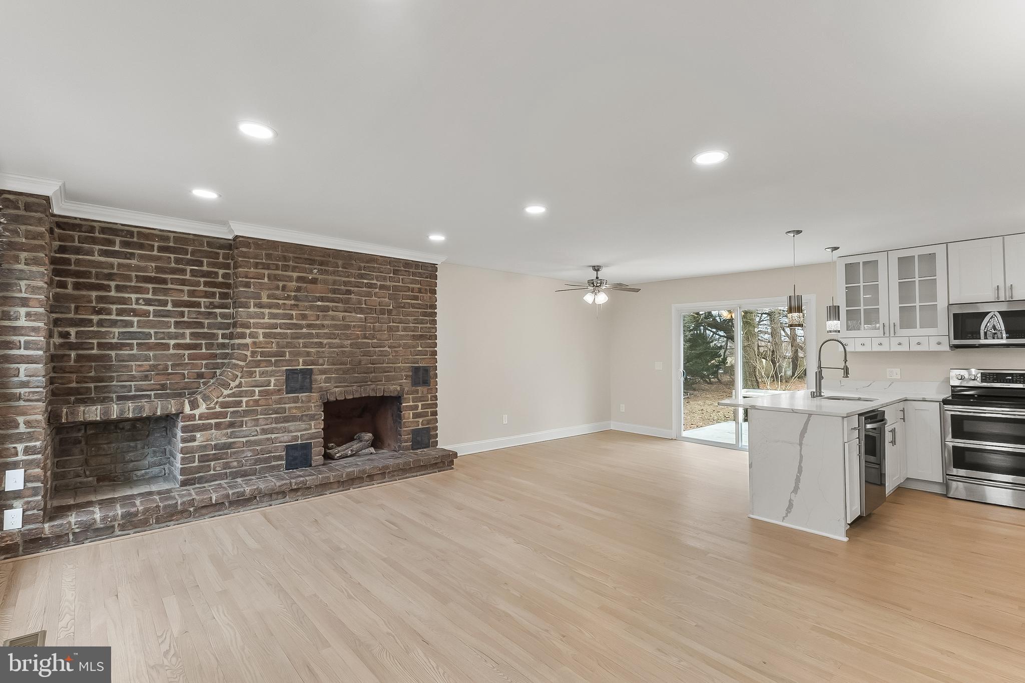 10546 Worton Road Worton, MD 21678 - Photo 10 of 33 an empty room with kitchen and fireplace