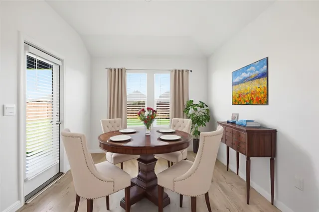 a view of a dining room with furniture and window