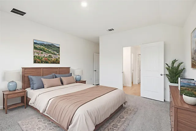 a bedroom with bed and a potted plant