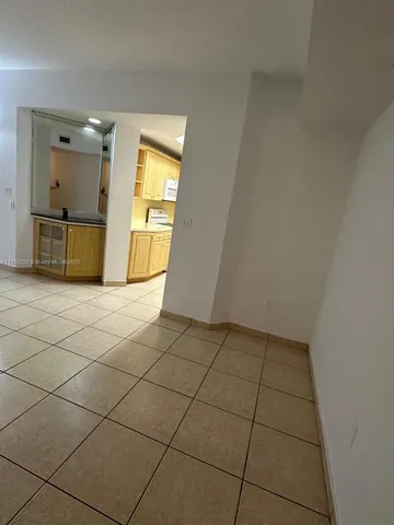 a view of a kitchen with kitchen furniture and empty shelves