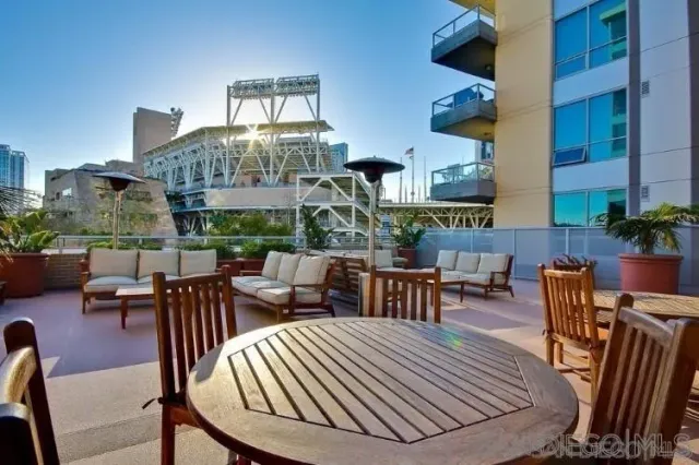 a view of a patio with couches and a potted plant on the table