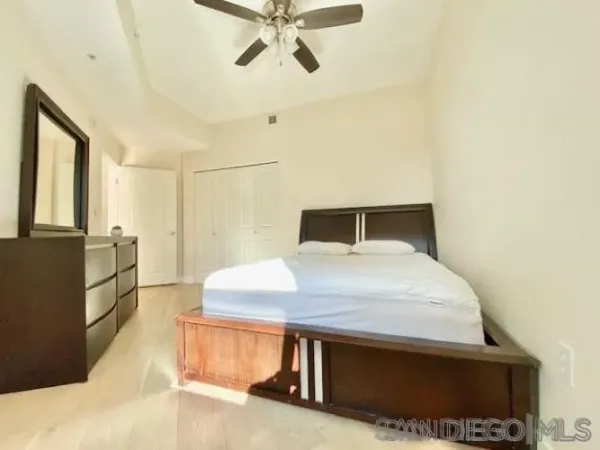 a bedroom with a bed and a dresser