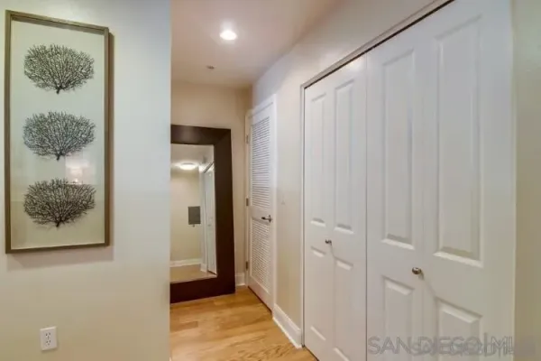 a view of a hallway with wooden floor