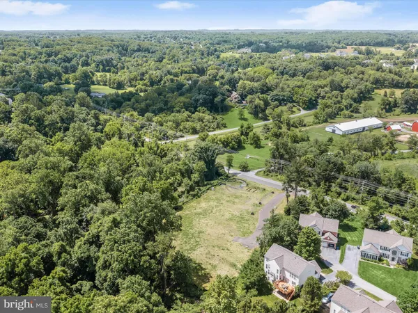 an aerial view of a houses with a yard