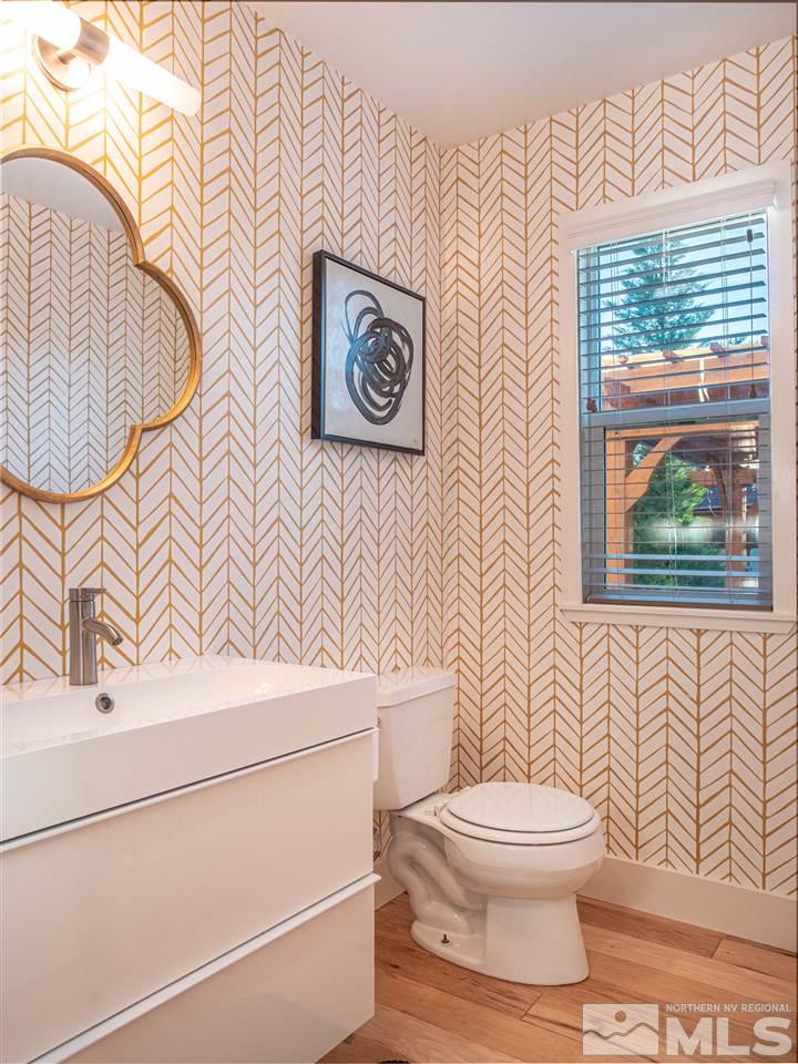 2435 Foley Way Reno, NV 89509 - Photo 14 of 32 a bathroom with a toilet a sink and a shower curtain