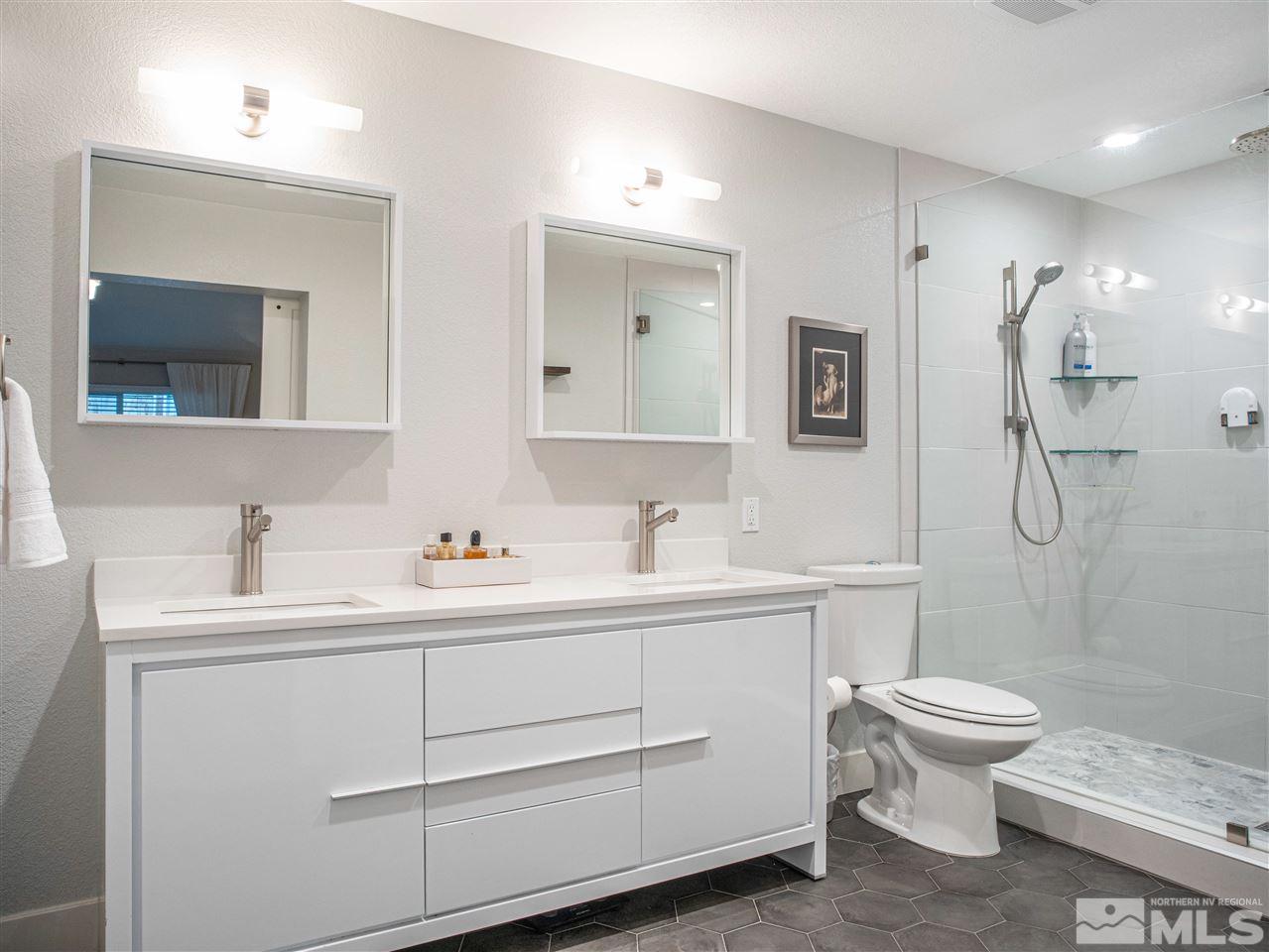 2435 Foley Way Reno, NV 89509 - Photo 19 of 32 a bathroom with a toilet sink and mirror
