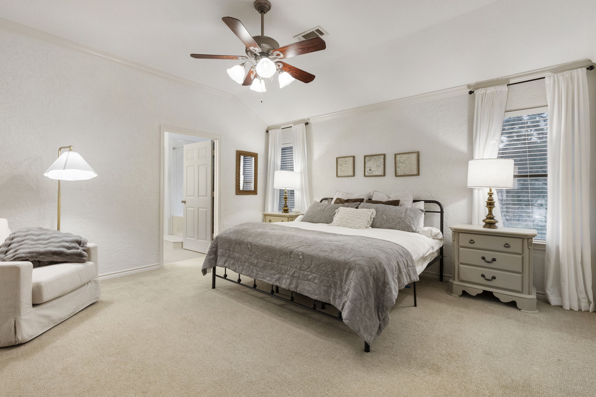 1898 Longmire Road, Unit 8 Conroe, TX 77304 - Photo 16 of 26 a spacious bedroom with a bed and a chandelier