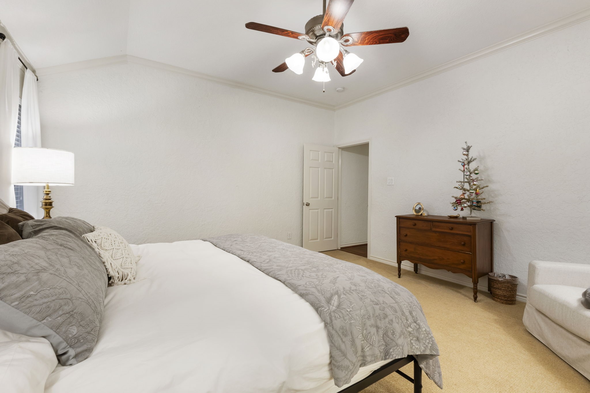 1898 Longmire Road, Unit 8 Conroe, TX 77304 - Photo 17 of 26 a bedroom with a bed and a chandelier