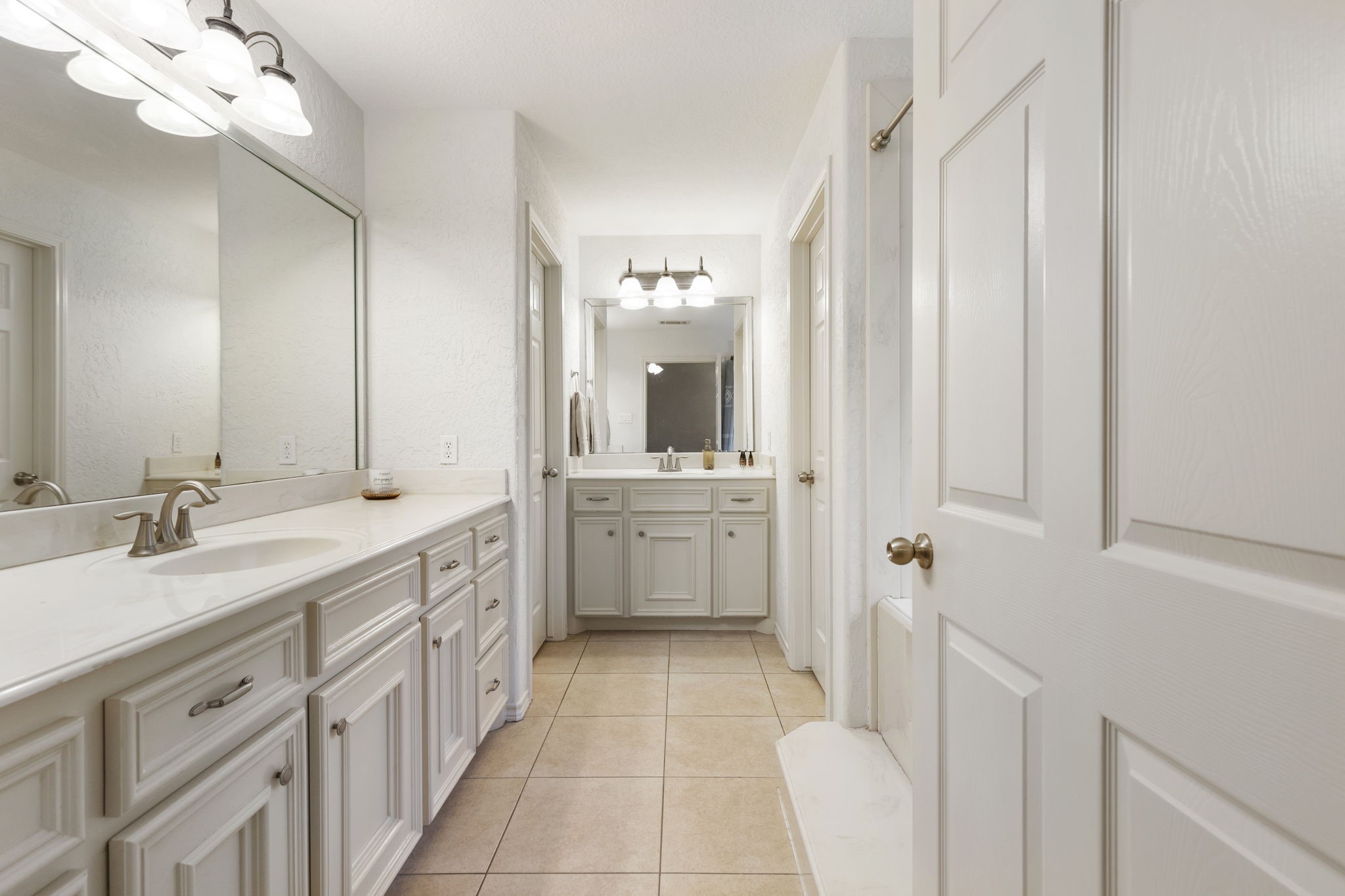 1898 Longmire Road, Unit 8 Conroe, TX 77304 - Photo 18 of 26 a spacious bathroom with a double vanity sink a mirror and a bathtub