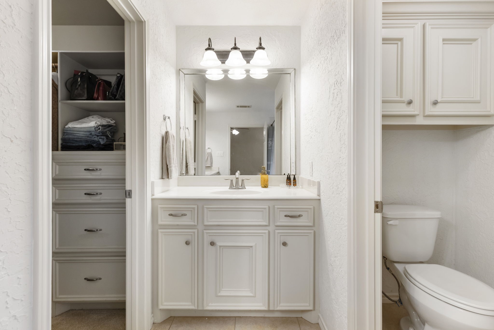 1898 Longmire Road, Unit 8 Conroe, TX 77304 - Photo 20 of 26 a bathroom with a toilet a sink and mirror
