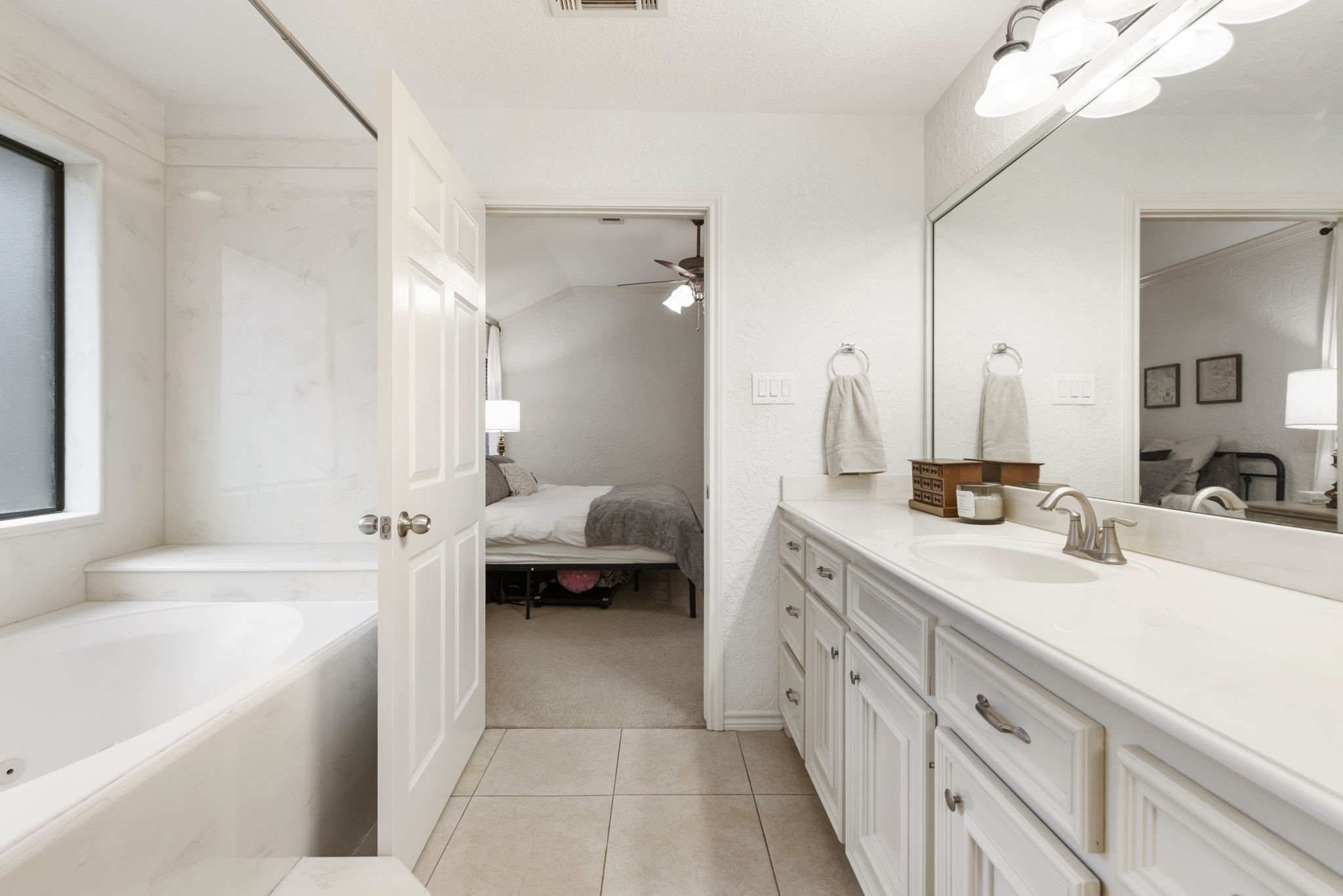 1898 Longmire Road, Unit 8 Conroe, TX 77304 - Photo 21 of 26 a spacious en suite bathroom with a tub double sink and mirror