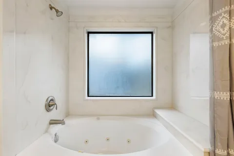 a white bath tub sitting next to a white sink