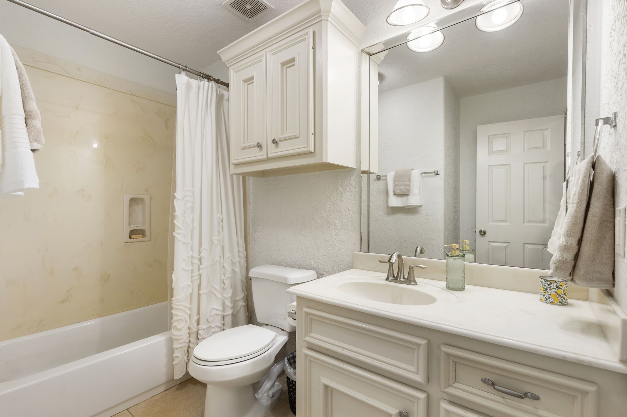 1898 Longmire Road, Unit 8 Conroe, TX 77304 - Photo 24 of 26 a bathroom with a sink a toilet and a large mirror