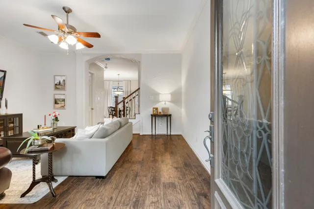 a living room with furniture and a chandelier