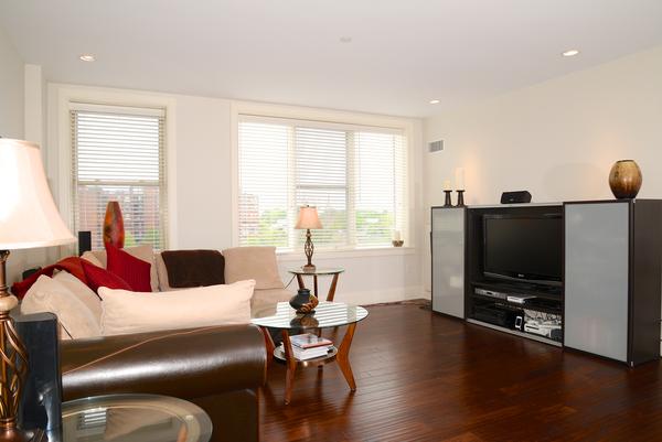 116-128 Rantoul Street, Unit 507 Beverly, MA 01915 - Photo 4 of 13 a living room with furniture and a flat screen tv