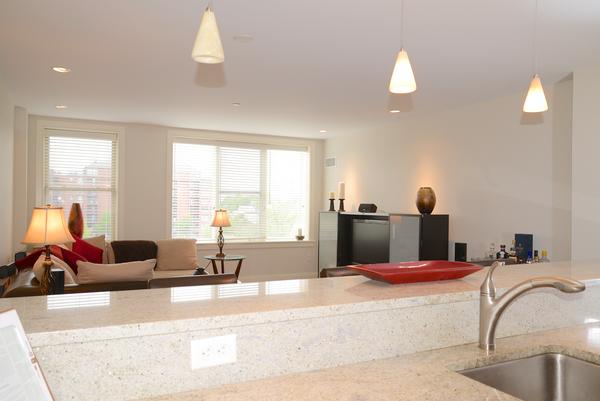 116-128 Rantoul Street, Unit 507 Beverly, MA 01915 - Photo 7 of 13 a bedroom with a bed and a large mirror