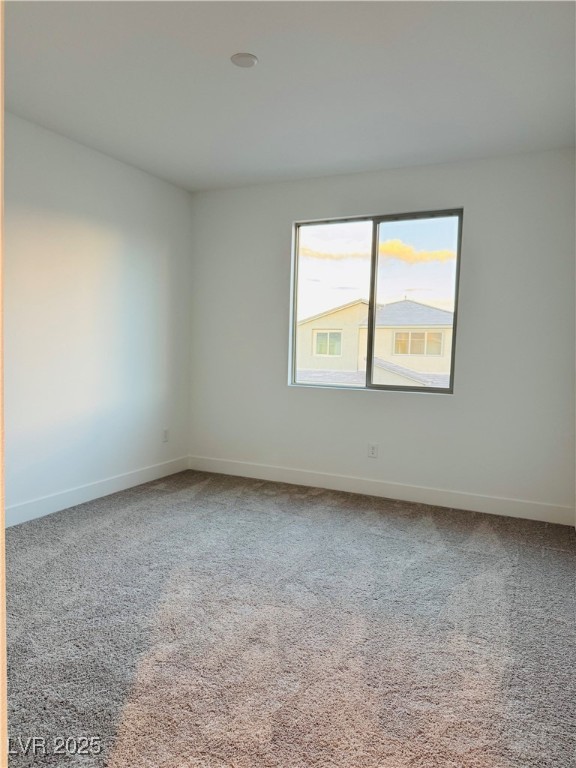 10237 Mystic Falls Drive Las Vegas, NV 89141 - Photo 15 of 23 Spare room featuring light carpet and baseboards