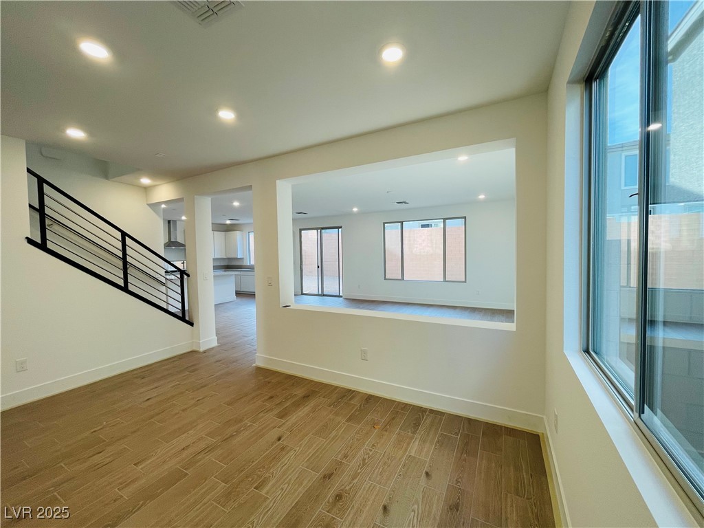 10237 Mystic Falls Drive Las Vegas, NV 89141 - Photo 3 of 23 Empty room with stairs, wood finish floors, and recessed lighting